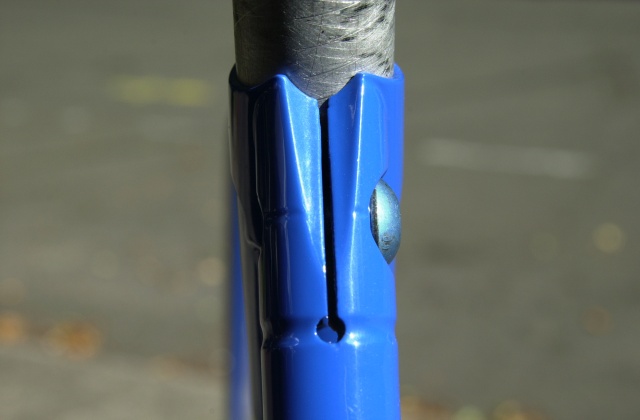 Integrated wishbone topstay seatpost binder.  Binder is actuated by a drilled out 10mm. class 10.9 alloy steel button head cap screw.