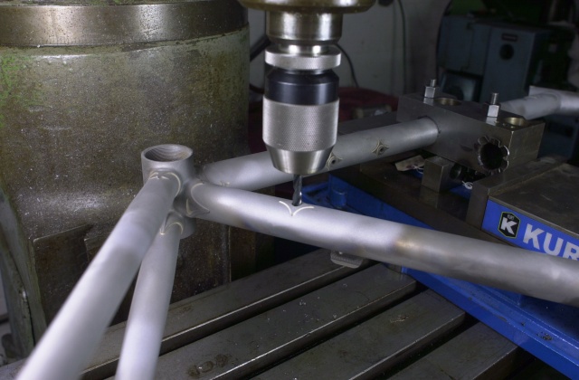 Di2 drilling of the seat tube.  Reinforcing diamond was silver brazed in position and then the frame is clamped in the mitre blocks and held in the Kurt vise on the Bridgeport for the drilling operation.