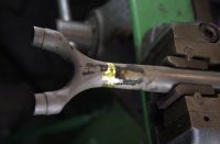 The brass brazed T&F designed road wishbone has been in and out of the hot tank soaking off the flux and is now held in the floating jaw vise in preparation for cleanup.