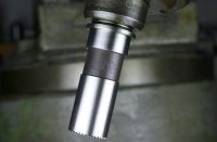 Today LAN71 tube mitre cutters (photo) are manufactured from PM T-15 powder metallurgy high speed steel supplied by the world's finest steel mills.  Typical chemical composition is 1.6% carbon, 4% chromium, 12.25% tungsten 4.9% vanadium and 5% cobalt and typical hardness is Rockwell C 66.  A high volume of hard vanadium carbides provides very high wear resistance.  The cobalt content provides excellent cutting edge strength at high service temperatures which is known as "red hardness".  Through the 1970's up until the late 1990's, LAN71 cutters were ground from M2 HSS.  Beginning around 2007 M42 high cobalt material was used and then in 2009 we switched to PM T-15 powder/particle metallurgy.  Powder metallurgy involves compacting millions of fine particles of steel which are even in size and uniform in carbide distribution into a bar of tool steel.  For the finest tube mitre cutters available today, all LAN71 cutters are turned and ground from PM T-15 for its superior wear resistance, red hardness, toughness and grindability.   While the cost of particle metal PM T-15 is greater than M2 and M42 cobalt high speed steel, the enhanced metallurgical characteristics greatly aid in machining the modern air hardening heat treated steel bicycle tubing.