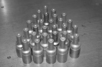 LAN71 Powder Metal PM-T15 HSS Mitre Cutters. The question of what rpm range is suitable for tube mitreing has come up several times.  The answer has several parts - machine rigidity, flood coolant or not, proper feed rate, cutter diameter, tube material hardness, tube gauge, etc., are some of the factors.  One place to start to determine a good rpm is to use a surface feet per minute table for drilling - this seems to be conservative even though the chip flow created by a drill bit is not the same as that from a tube mitre cutter.  To simplify, let's assume a small mill is used without flood coolant, hand feeding, 1-1/8" (28.6mm.) cutter, 4130 material with a Brinell hardness of 179 and a 0.9mm. wall thickness.  Published tables of surface feet per minute (SFM equals the cutter circumference times RPM) for drill bits show a range from 60 to 90 feet/min for material with a Brinell hardness under 200 which 4130 satisfies.  RPM equals 3.814 times the SFM divided by the cutter diameter in inches, which for a 1-1/8" cutter gives a range from 200 to 300 rpm.  If the material is heat treated and has a Rockwell (RC) hardness number between 35 and 40, the resulting rpm drops to between 100 to 135 rpm.  With a little trial a good speed with the parameters unique to the condition will be found.