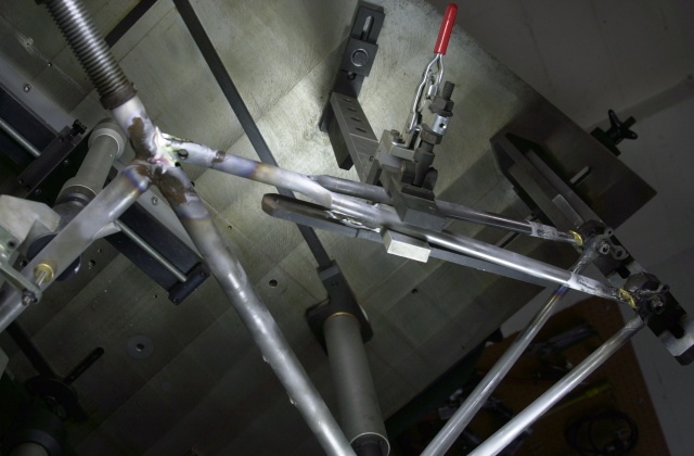 Photo of Donald's frame after completing rear triangle brazing.  Marchetti fixture clamps the rear triangle ensuring proper alignment.  Fixture is rotated so that the seatstays are vertical for brazing to the dropouts and then rotated so that the seat tube is horizontal to aid silver brazing flow at the seat lug/top stay binder joint.